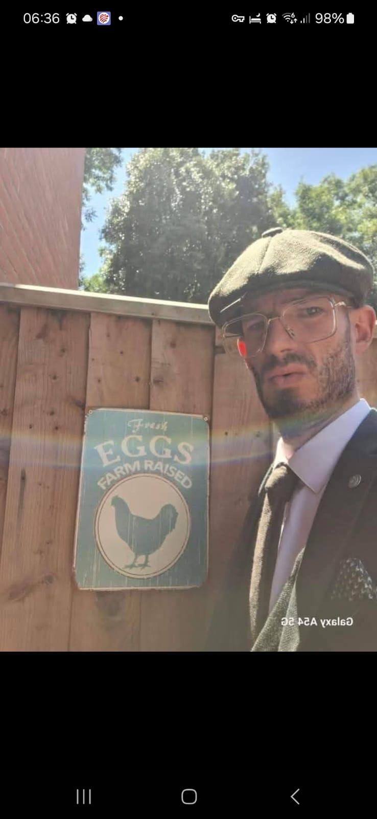 Reece beside his fresh eggs sign